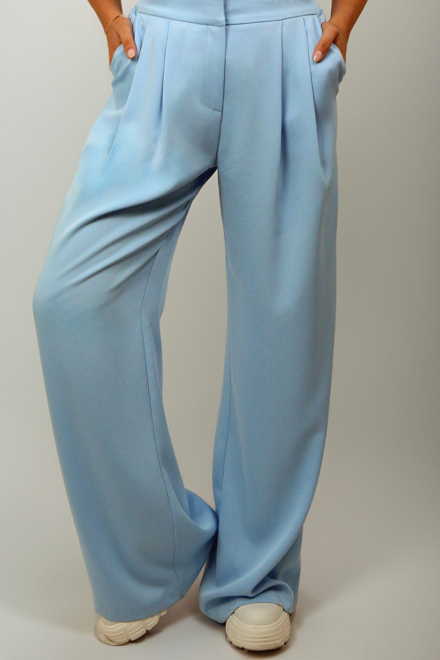 Zina Set featuring blue embroidered details and floral accents on a belt and cuffs.