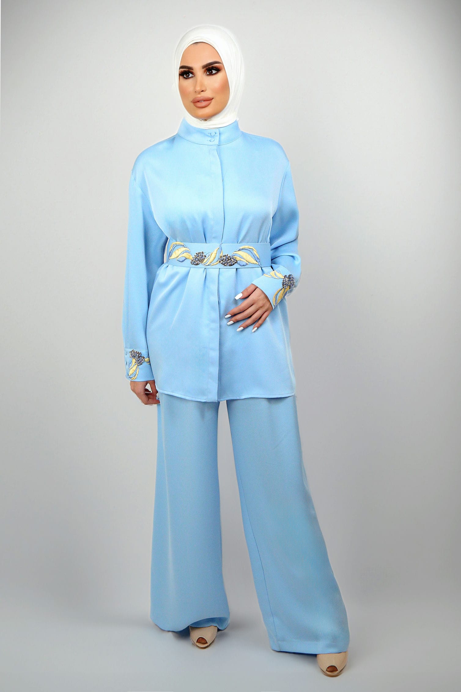 Zina Set featuring blue embroidered details and floral accents on a belt and cuffs.