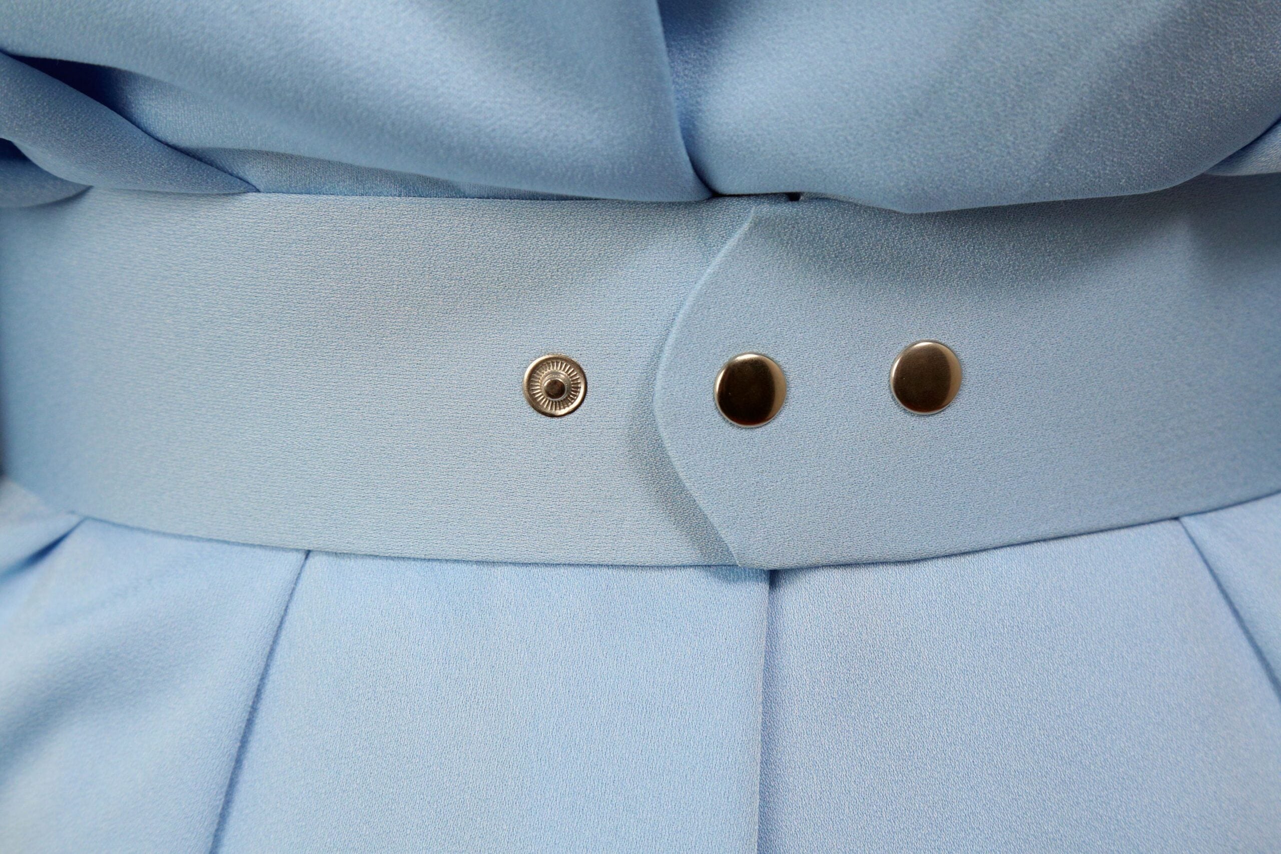 Close-up of the blue belt and buttons on the Zina Set, showcasing elegant design details and craftsmanship.